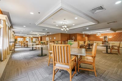 Bright and spacious common area with dining tables