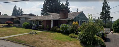 Exterior view of a single-story care home with garden
