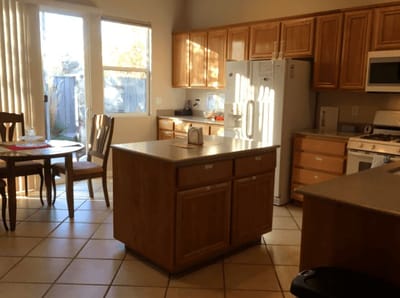 Bright kitchen area with wooden cabinets and table