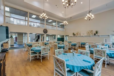 Bright dining area with tables and chairs set for meals