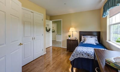 Private room with a bed and dresser