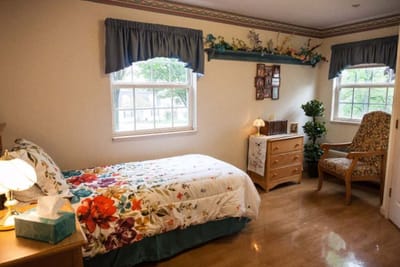 Cozy resident room with floral bedding and natural light