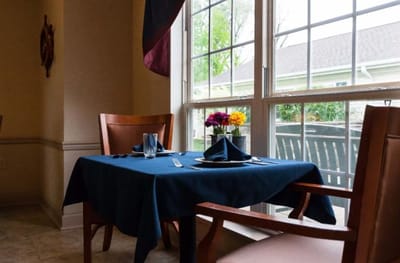 Table setting in a dining area with flowers.