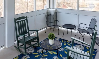 Cozy sunroom with seating and decor at a senior living facility