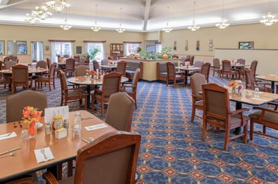 Bright dining room with tables set for meals
