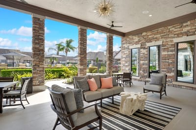 Outdoor seating area with stone accents and palm trees
