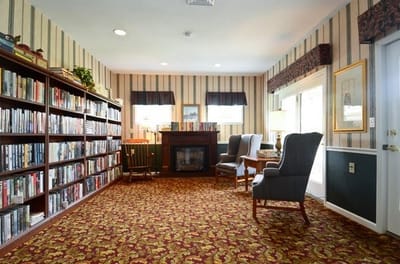 A cozy reading room with bookshelves and seating