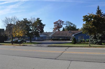 Exterior view of Autumn Oaks facility with tree-lined street