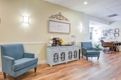 Common area with seating and decor in a senior living facility