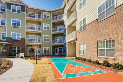 Outdoor shuffleboard court in a senior living community.