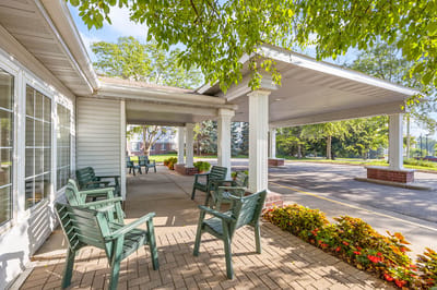 Outdoor entrance with seating and floral landscaping