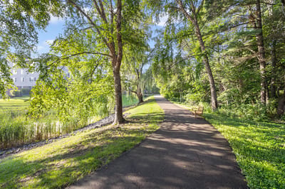 Scenic pathway through lush landscaping near the facility