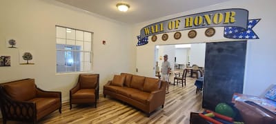 Cozy common area with chairs and a wall of honor