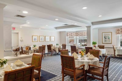 Bright dining room setup with tables and flowers
