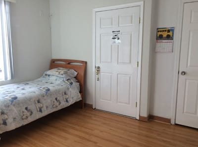 Private resident room with bed and calendar