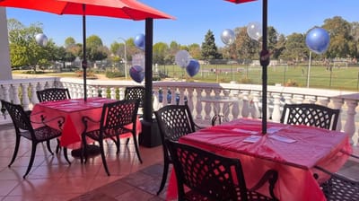 Outdoor dining area with tables and umbrellas