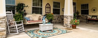 Outdoor seating area with rocking chairs and decor