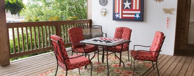 Outdoor seating area with red chairs and a game table