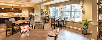 Bright common area with tables and large windows