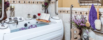 A relaxing bathroom with a spa tub and flowers