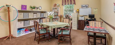 Bright activity room with seating and storage.