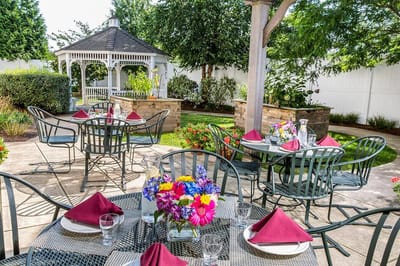 Outdoor dining area with tables and flower arrangements