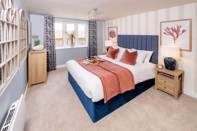 A well-furnished bedroom with soft decor and natural light