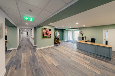 Bright lobby area with reception desk and artwork