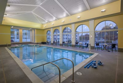 Indoor swimming pool area with large windows