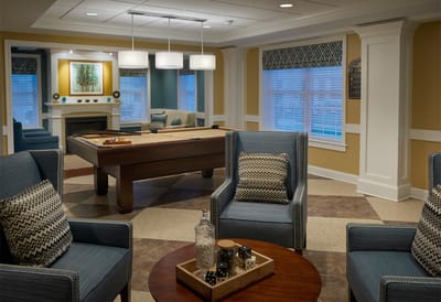 Bright and inviting common area with game table