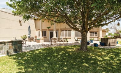 Outdoor area with seating and shaded trees