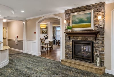 Cozy common area with a stone fireplace and artwork