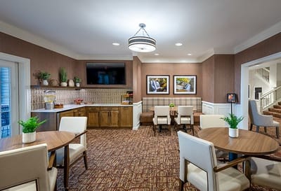 Bright common area with dining tables and modern decor