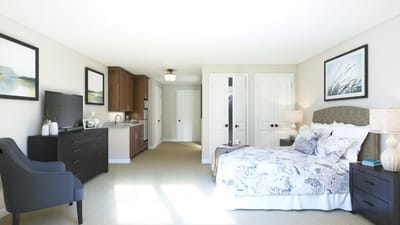 Interior view of a private resident room with bed and furnishings
