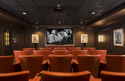 Interior of a theater room with red seating