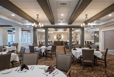 Bright and spacious dining room with tables set for meals