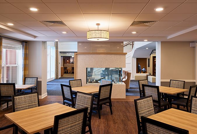 Bright dining area with tables and a fireplace