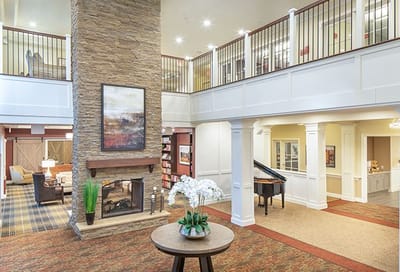Bright and inviting lobby area with piano and seating