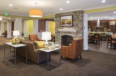 Interior common area with seating and kitchen in background