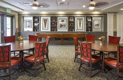 Common area with tables and artwork on the wall