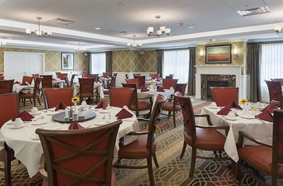 Dining room set for a meal with tables and chairs
