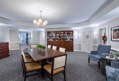 Common area with dining setup and bookshelf