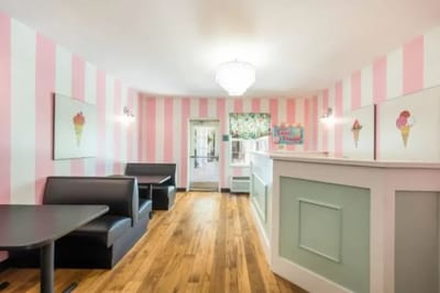 Interior view of a colorful common area with booths