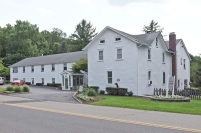 Exterior view of Bryan Manor with gardens