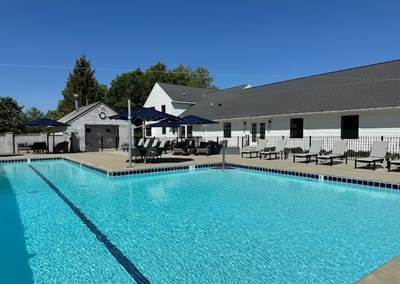 Outdoor pool area with lounge chairs and umbrellas