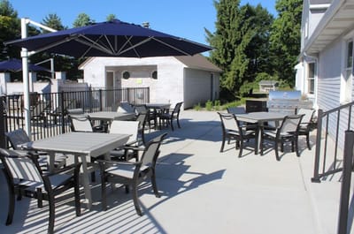 Outdoor seating area with tables and umbrellas