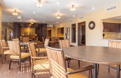 Common area with tables and chairs in a bright room