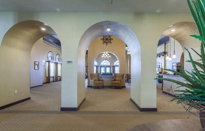Interior view of a common area with arches and seating