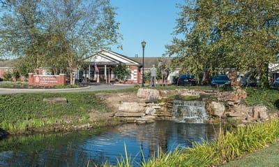 Outdoor view of Capetown Senior Living with a pond