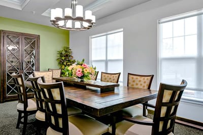 Cozy dining area with a large wooden table and floral centerpieces